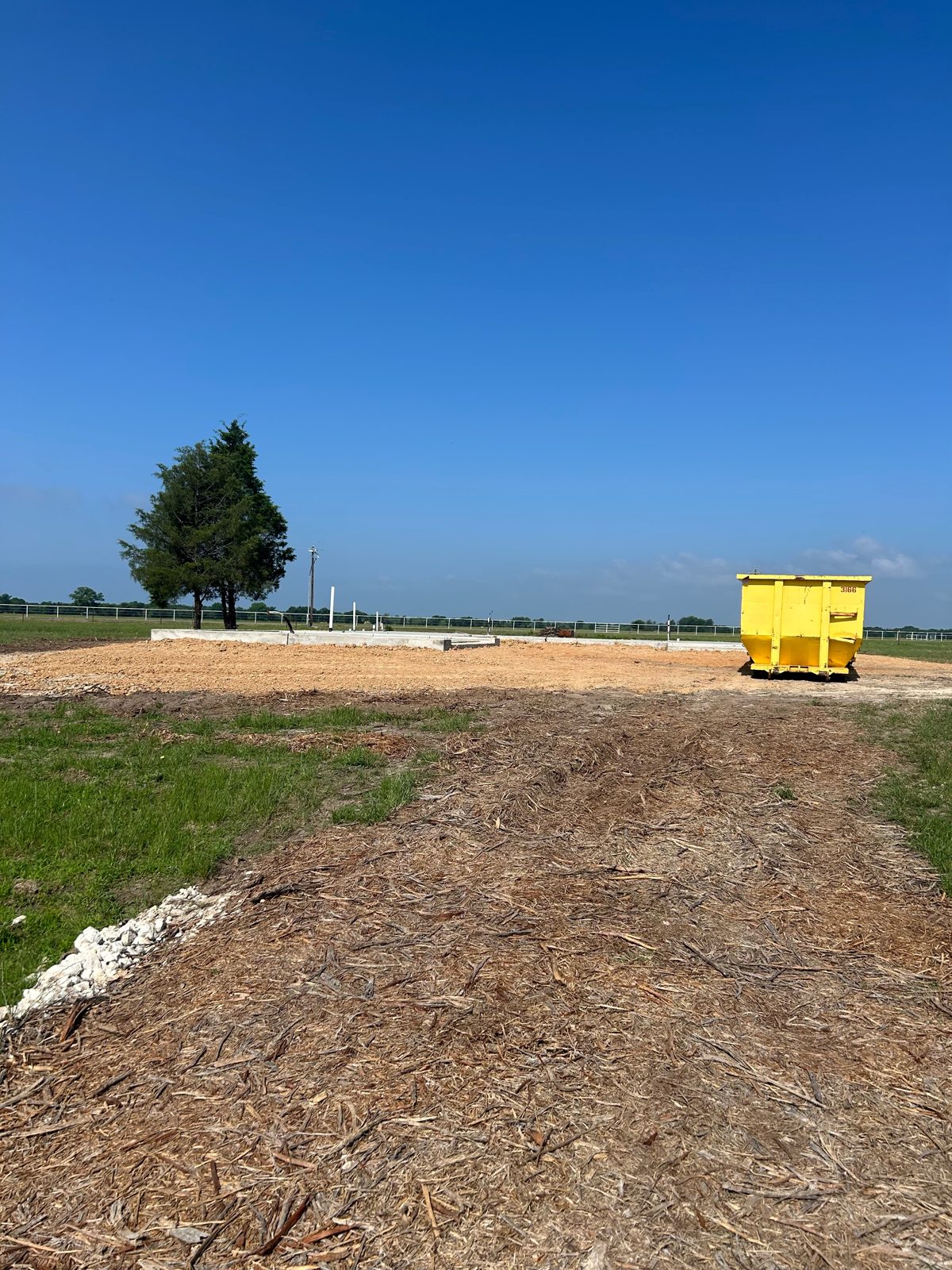 Cleared lot with poured slab, ready for framing